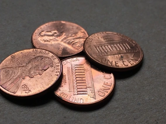 A close-up image of four pennies